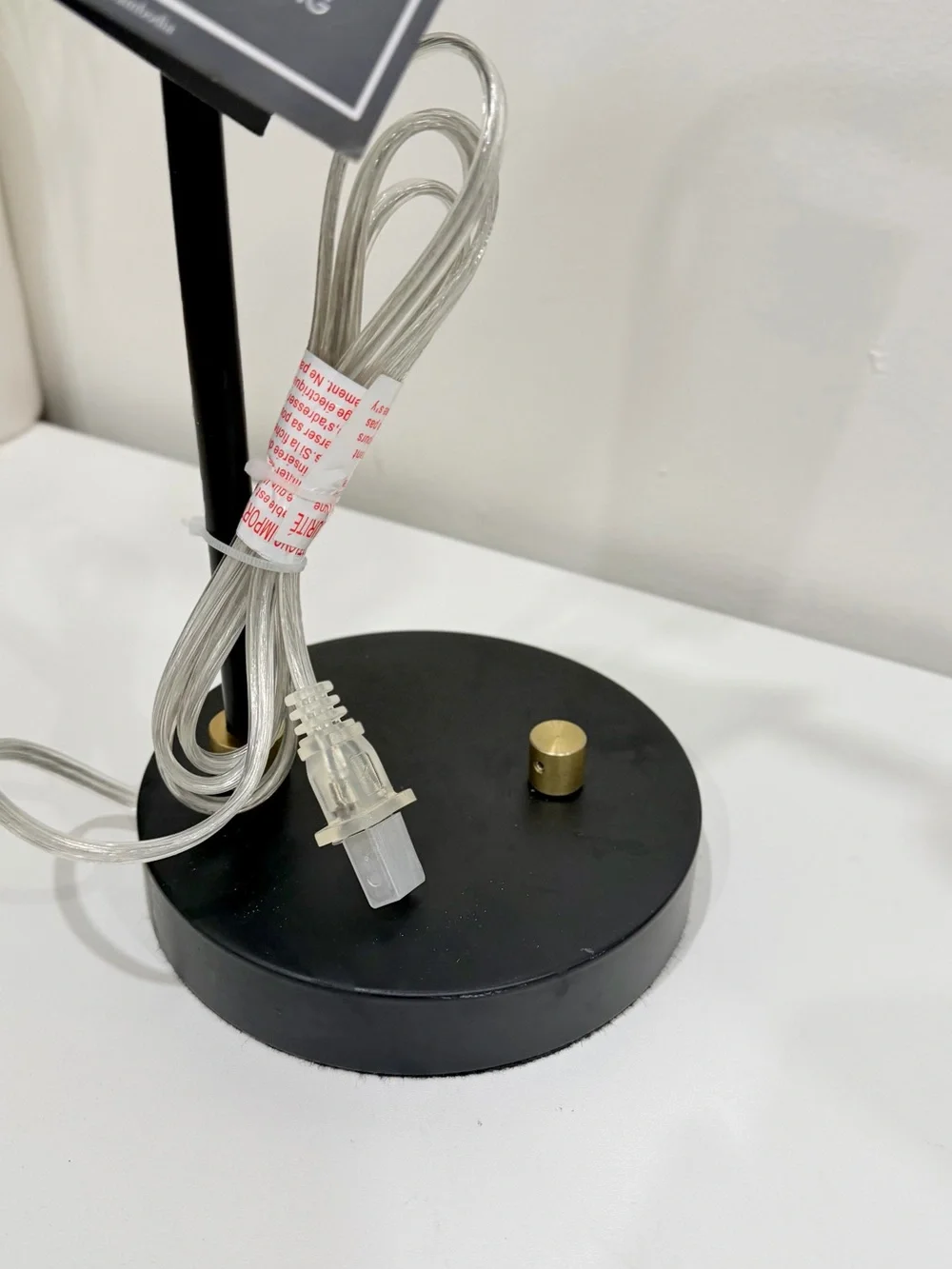 black and brass desk lamp with a small wooden accent piece on the socket